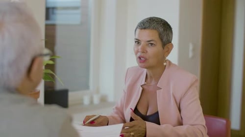 Woman Consulting with Senior Man in Home Office