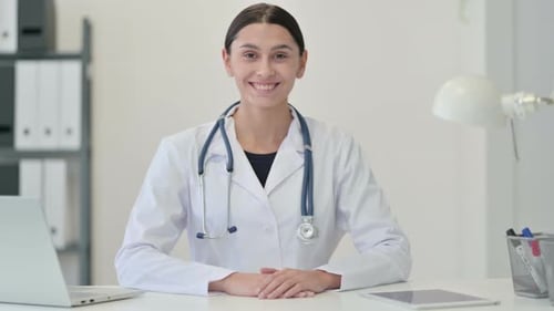 Female Doctor Smiling in Clinic at the Camera
