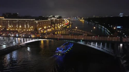 Flying over a night city bridge