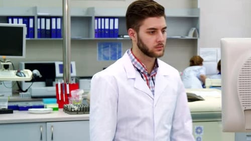 Male Scientist Working on Computer in Laboratory