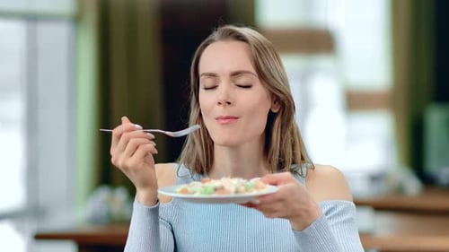 Woman Enjoying Salad in Home Interior