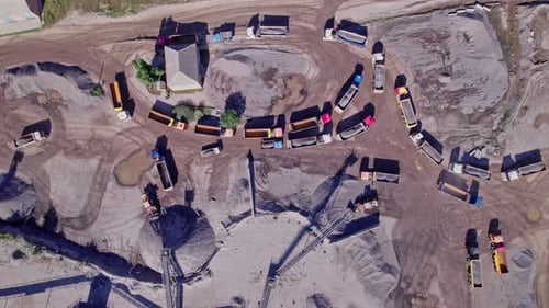 Excavator Loading Crushed Stone Into a Dump Truck in a Crushed Stone Quarry