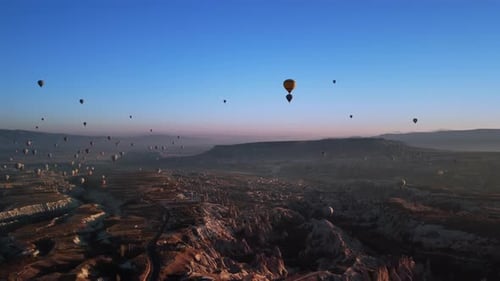 Amazing Landscape of Volcanic Hills Valley and Levitating Balloons in the Air Against Mountain Ridge