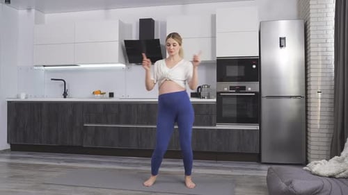 Pregnant Woman Dancing in Kitchen