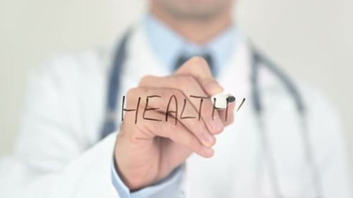 Doctor Writes 'Healthy' with Marker on Clear Surface