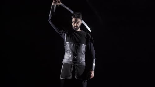 Intense Man with Sword in Dark Setting