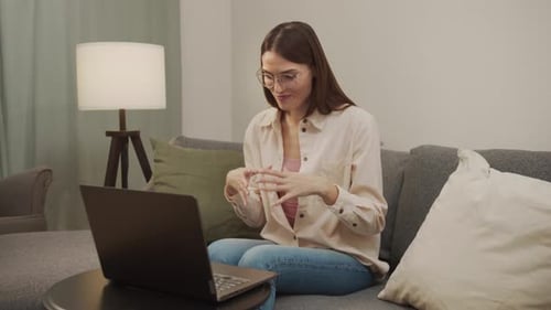Young Woman Video Calling on Laptop at Home