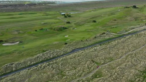 Aerial view over marram grass anchored dunes and golf course
