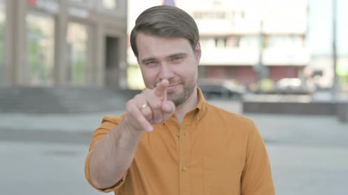 Man Beckoning Hand Gesture in Urban Environment
