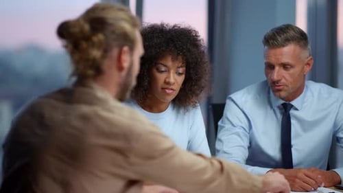 Business Meeting Concludes with Handshake in Modern Office