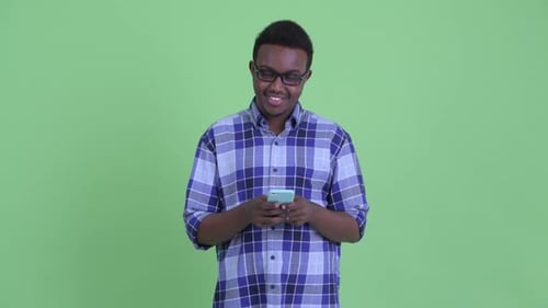 Young Adult Using Mobile Phone on Green Screen