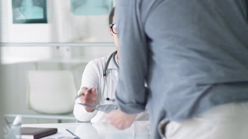 Doctor Explains X-Ray to Patient in Modern Office