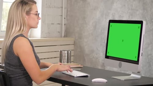 Woman Working at Computer with Green Screen
