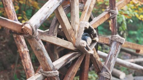 Die Mühle treibt das Wasser im Fluss im Herbstwald bei bewölktem Wetter