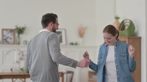 Happy Couple Dancing Together in Living Room