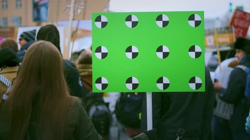 Banner in a Crowd of People Copy Space Text. Girl with a Empty Poster on Strike.