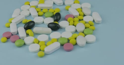 Colorful Pills and Capsules on Blue Background