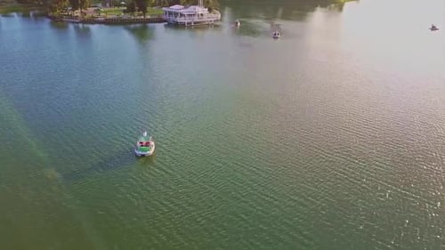Flycam Moves Fast Over Amazing Quiet Lake Water with Boat