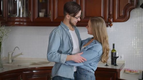 Affectionate Couple Embracing in a Cozy Kitchen