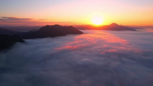 4K Aerial view flying in fog. clouds at sunset fog.