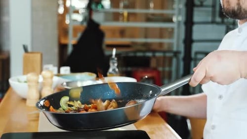 Chef Tossing Vegetables in Frying Pan