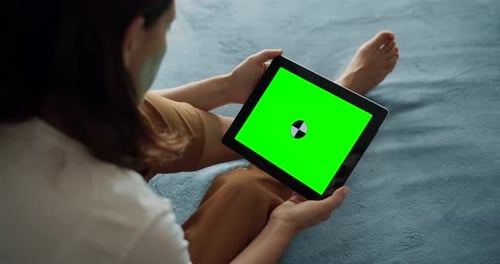 Woman Holding Tablet with Chroma Key Screen Indoors