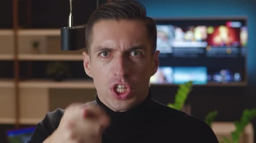 Close Up Angry Indignant Man Shouting and Pointing at Camera at Living Room