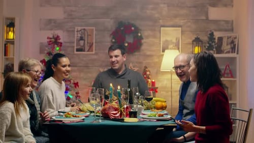 Family Taking Christmas Selfie at Holiday Dinner