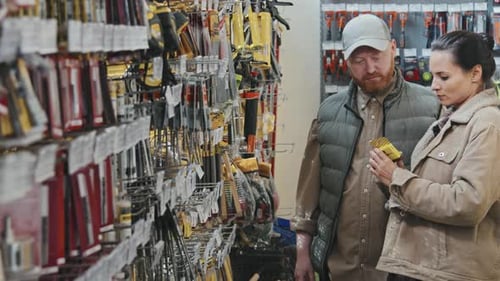 Man and Woman Talking and Shopping at Hardware Store