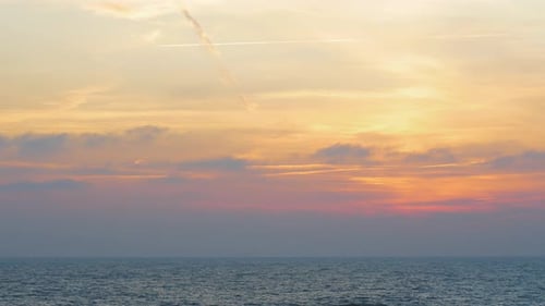 Romantic sunset in to the sea though the clouds