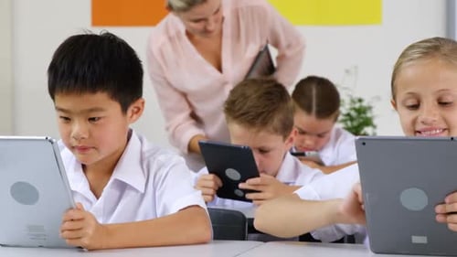 Elementary Students Working with Tablets in Classroom