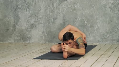 Man Practicing Yoga in Half Hero Stretch Pose