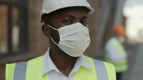 Construction Worker Wearing Hardhat and Face Mask