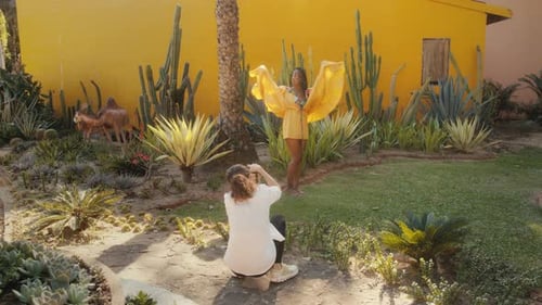 Woman in Yellow Dress Posing in Sunny Garden
