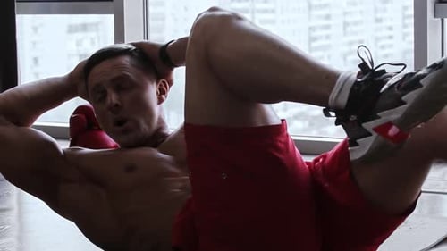 Shirtless Man Doing Crunches on Yoga Mat