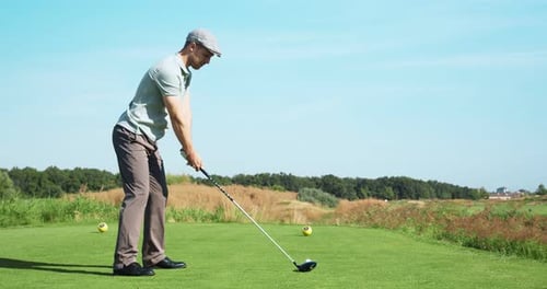 Man Playing Golf on Green Course