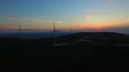 Aerial view of white elegant windmills at sunset