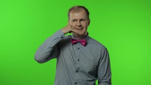 Man Makes Call-Me Gesture on Green Screen
