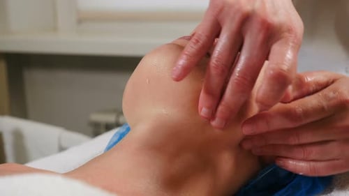 Hands Giving Facial Massage in Spa Setting
