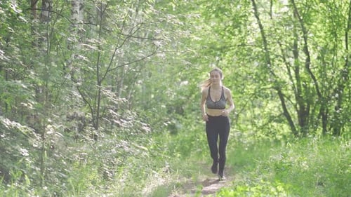 Young Woman Runner Training in Summer Park