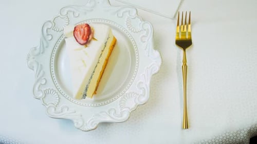 Cake Slice Garnished with Strawberry on White Plate