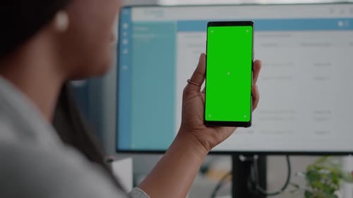 Closeup of African Woman Holding Mock Up Green Screen Chroma Key Phone with Isolated Display