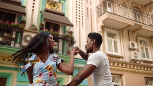 Happy Couple Dancing in City Street