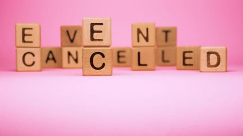 Event Cancelled on Wooden Cubes. Cancelled Word Made with Building Blocks. Mass Gathering Cancelled