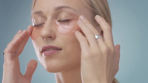 Woman Applies Beauty Eye Patches for Skincare Routine