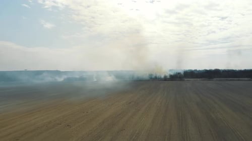 Aerial Flight Over the Fire in the Field