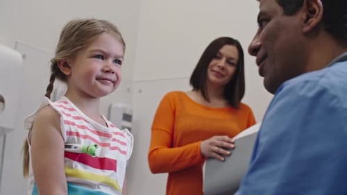Doctor Measuring Temperature of Little Patient
