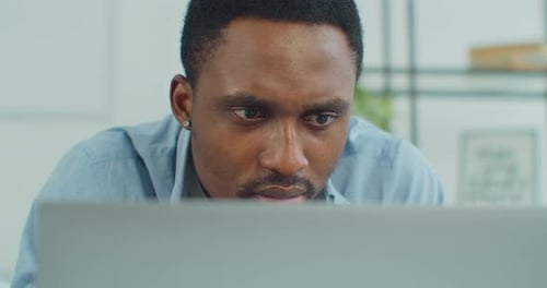 Close Up of Man Focused on Laptop Screen