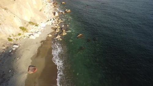 Aerial View From Above on Calm Azure Sea and Volcanic Rocky Shores