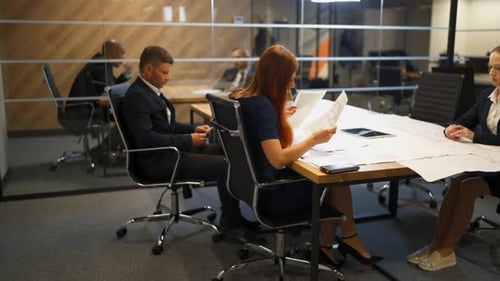 Few Employees Work with Documents and Drawings in Modern Office.